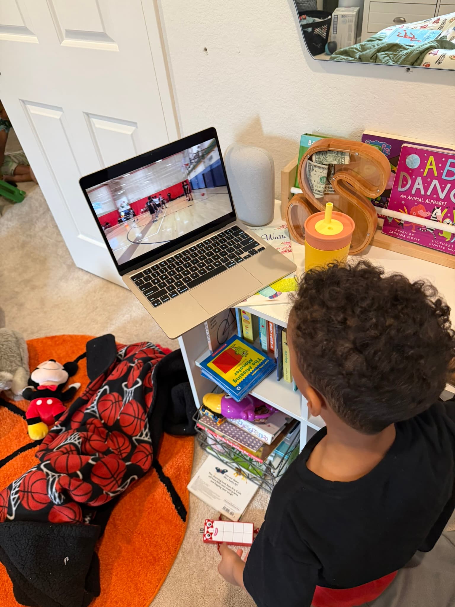 A young fan watching the live game on a laptop in their bedroom
